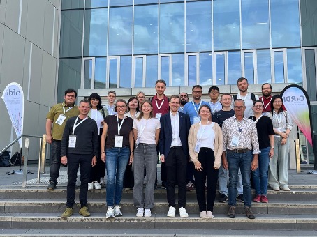 Group foto of the NFDI4Energy team in front of the entrance of the conference building